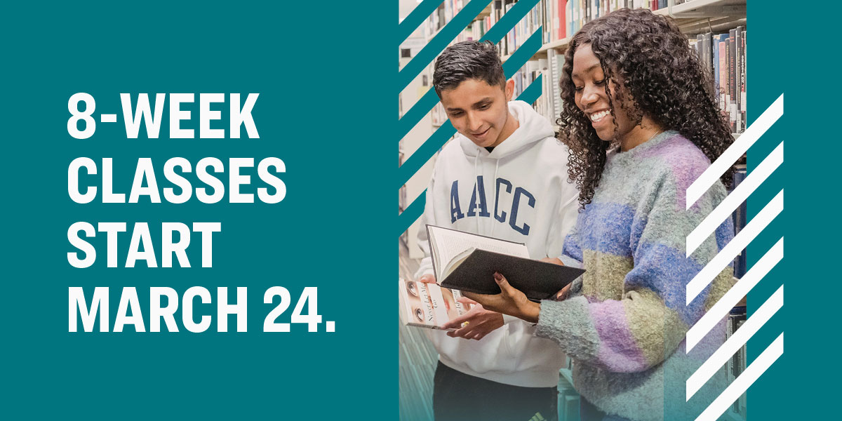 Two students holding books in library. Text that says, 