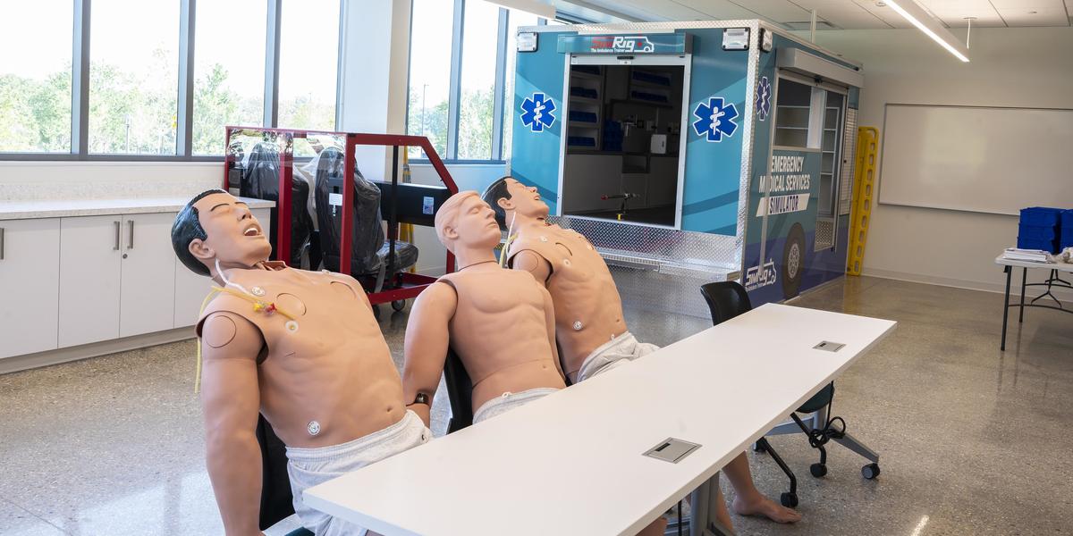 Image of three manikins sitting.