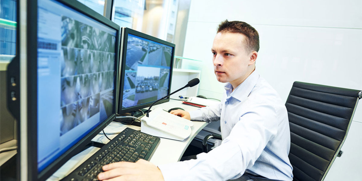 Man monitors computers