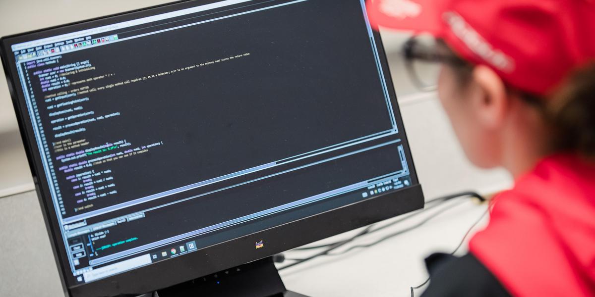 Student coding on a computer.