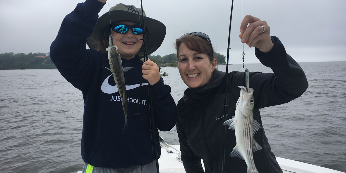 1200x600 image of Julie Grignon with family member on a boat.