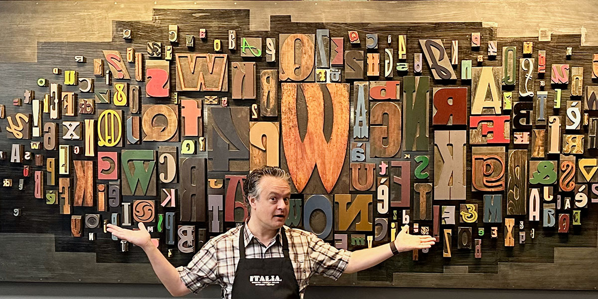 Picture of Erik Dunham in front of typography