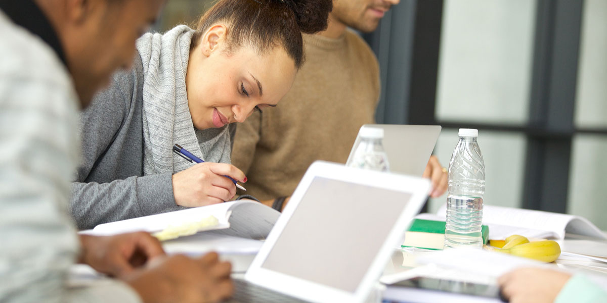 Female student studying with a group.