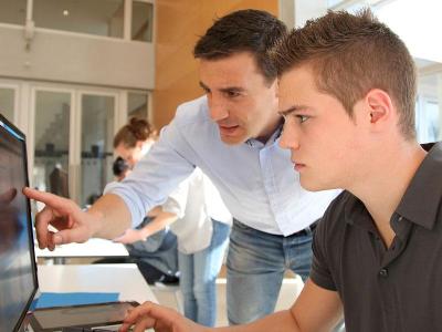 Instructor and student using a computer.