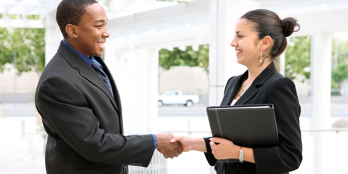 Student employee shaking hands with employer.