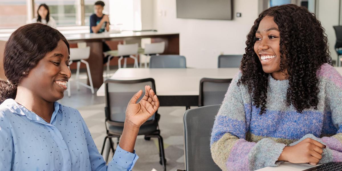 Two students talking to one another.