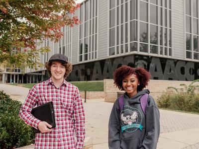 Students standing in front of library