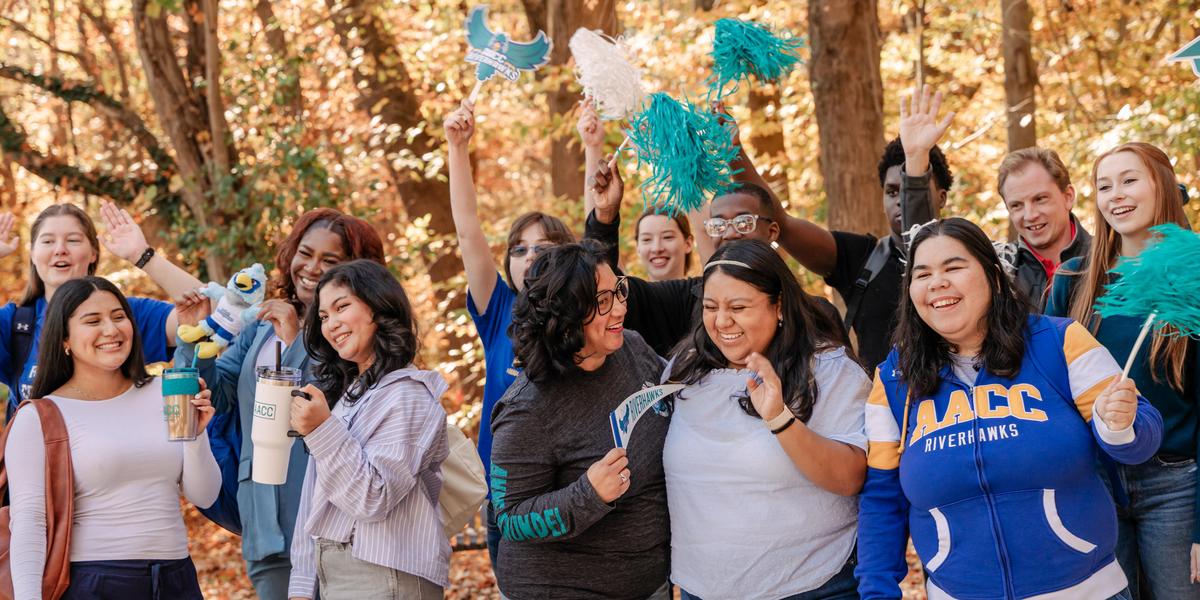 Students smiling and cheering with AACC gear.