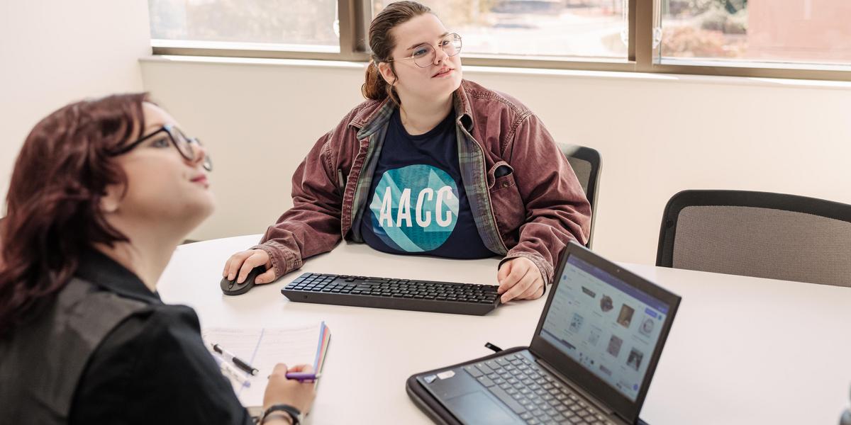 Students looking at screen while studying together.